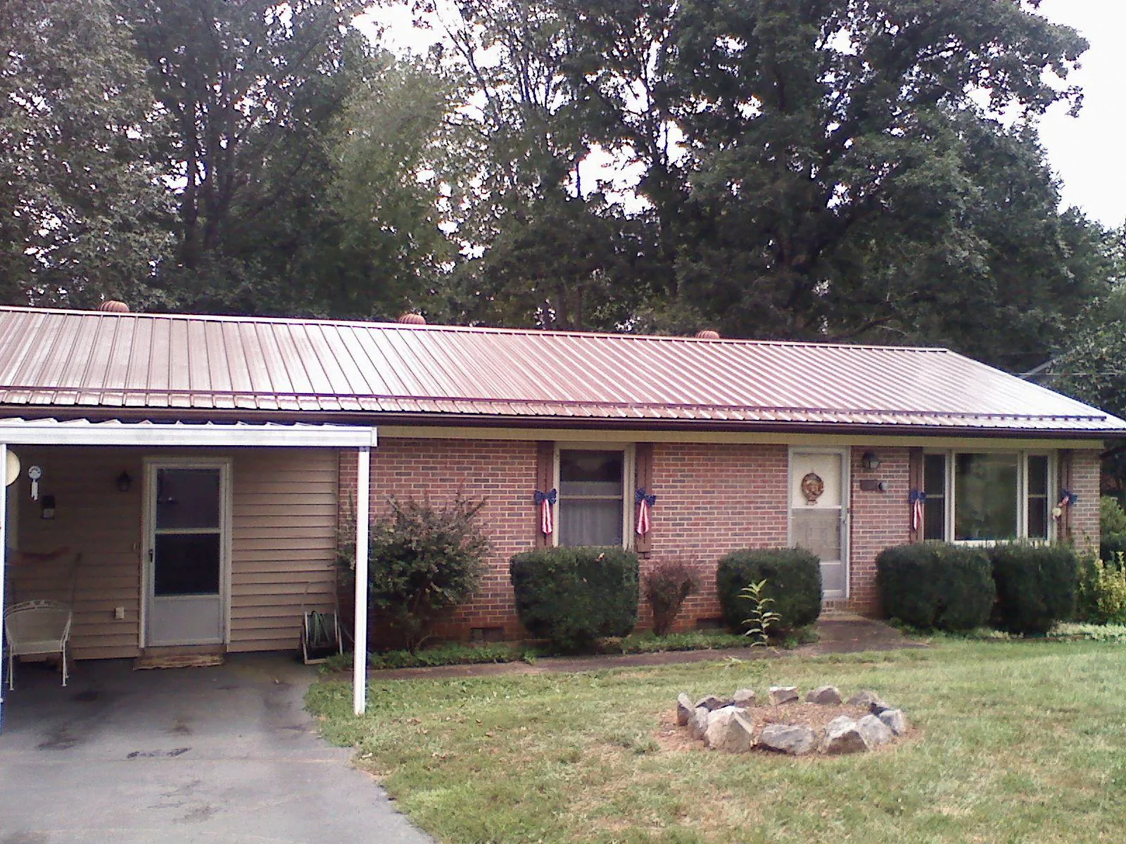 Bronze metal roof and carport on a brick ranch home — Roof Repair work by our crew in Libertytown