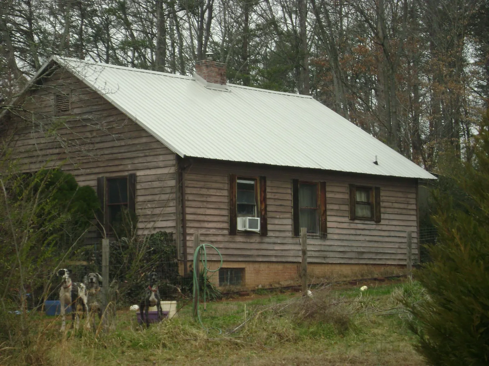White metal roof on an old wood sided farmhouse, from a Metal Roof Installation job in Libertytown